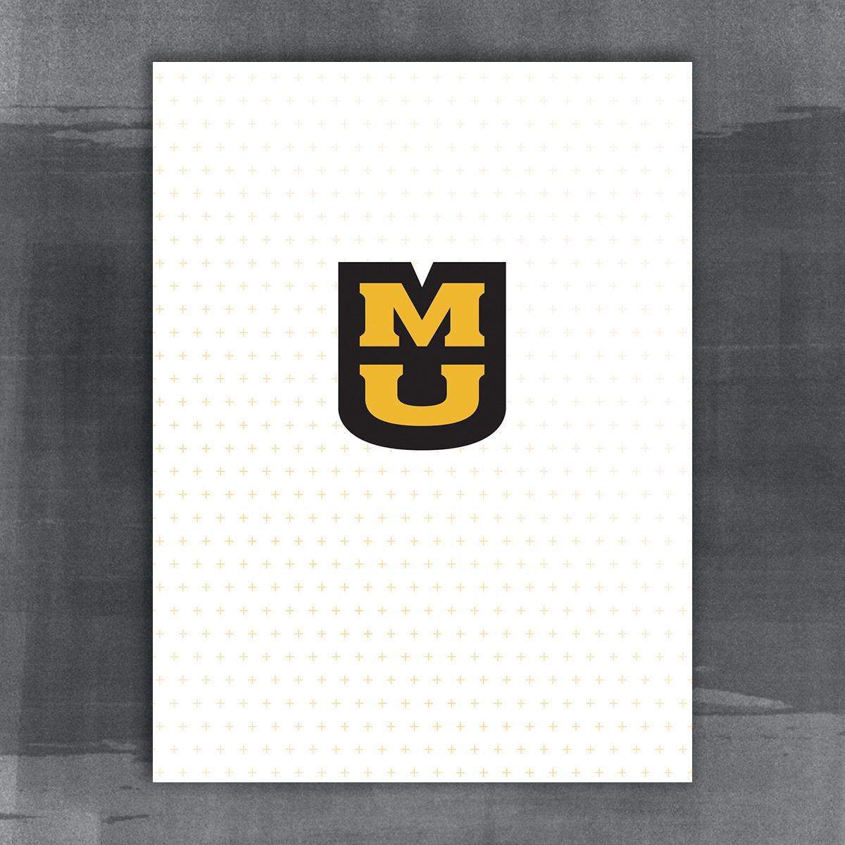9x12 pocket folder. White with gradient gold plus pattern. Stacked MU in the center